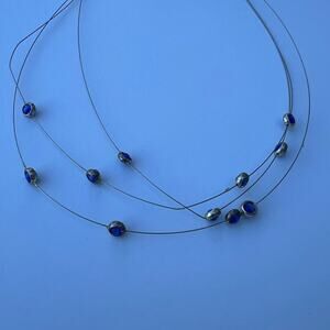 Icing women's choker necklace multiple strands with attached blue beads.